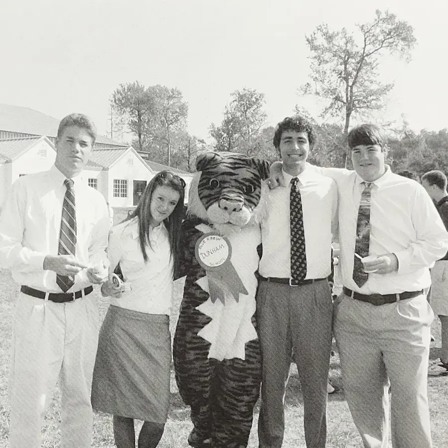 Four high school students with Tiger mascot celebrating National Blue Ribbon School award