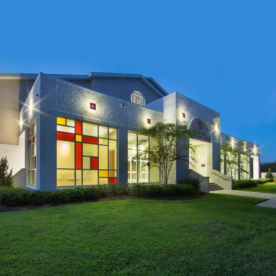 Exterior photo of the Brown-Holt Chapel Arts Center at night