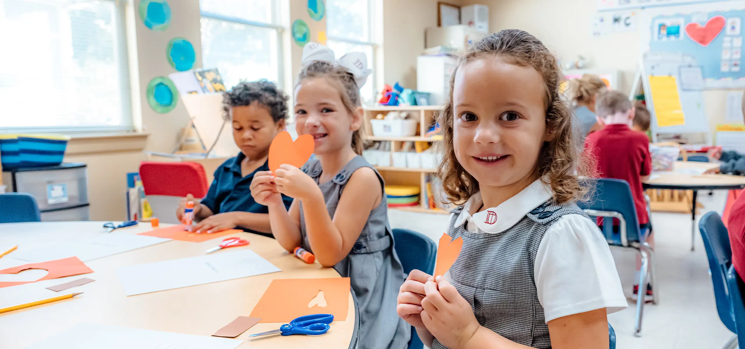 Dunham Lower School students holding up paper hearts