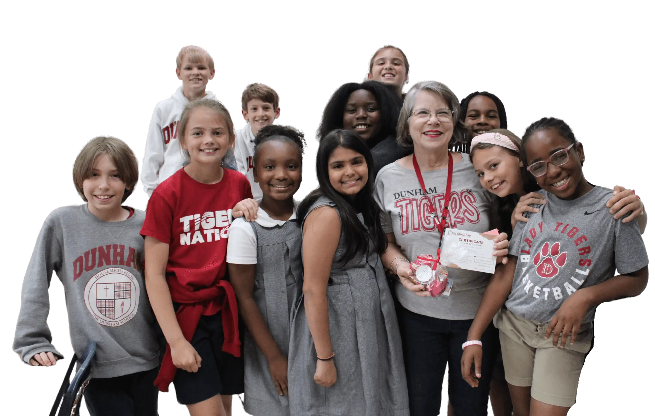 Dunham teacher standing with her students in a classroom