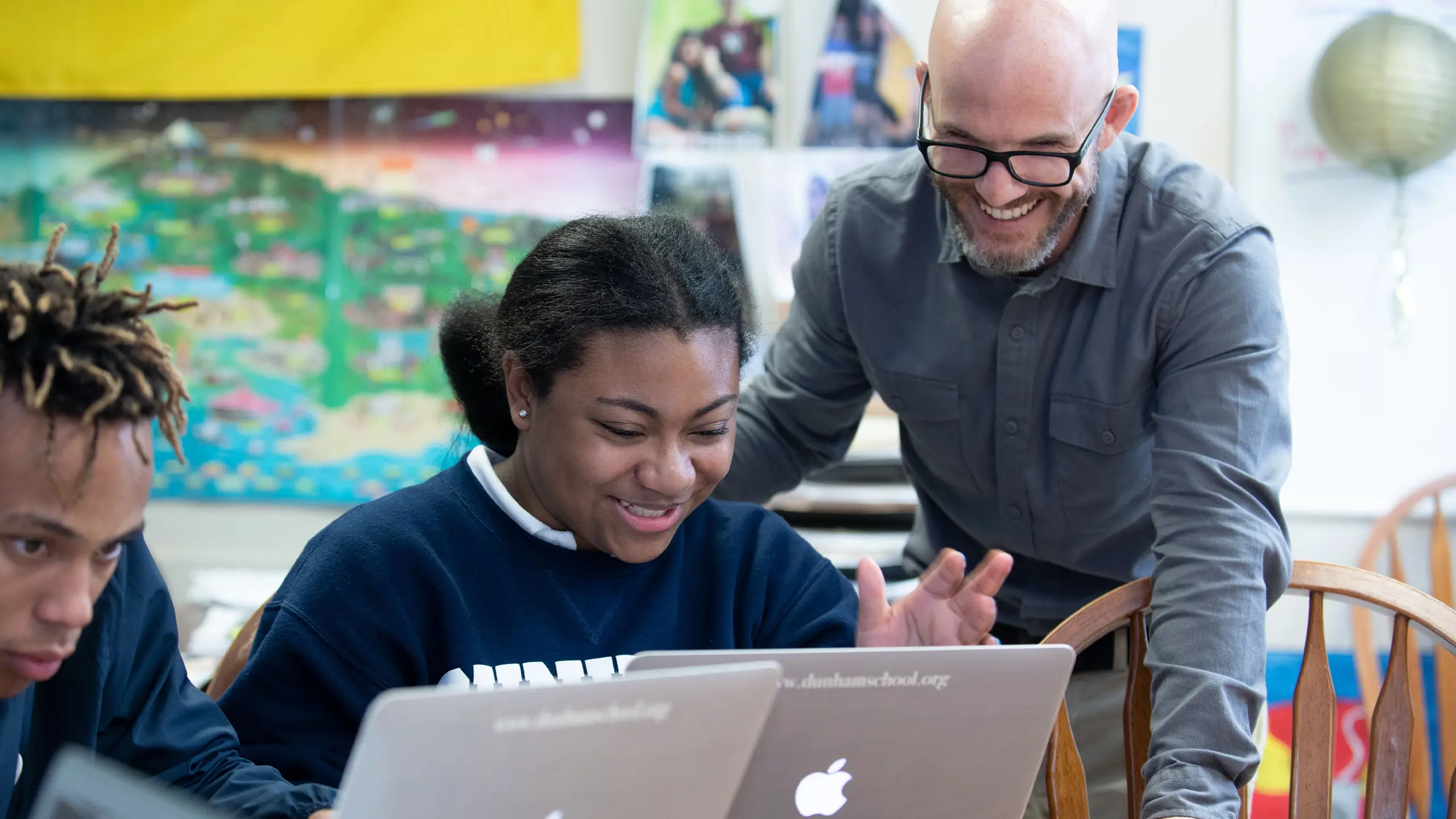 Dunham teacher and student working on MacBooks.