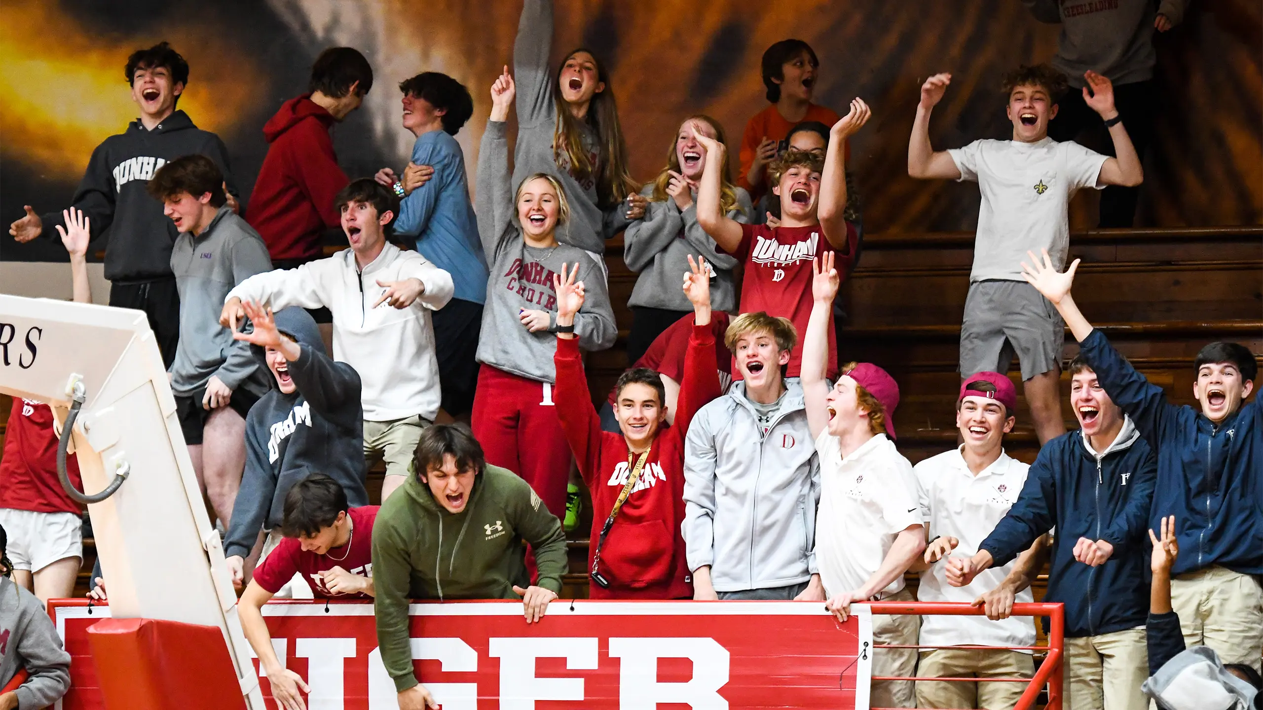 Dunham high school students cheering at an athletic event.