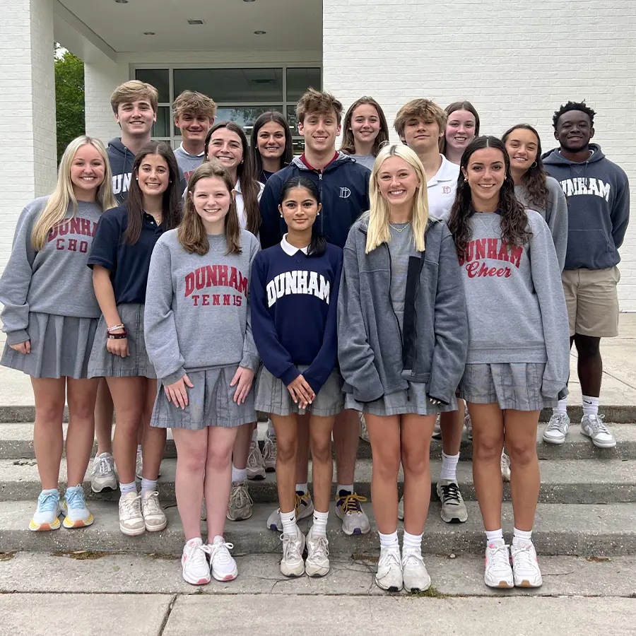 Dunham Upper School class officers standing in front of the Brown-Holt Chapel Arts Center.