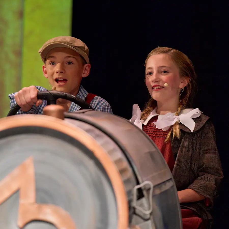 Two Middle School performers acting during musical.