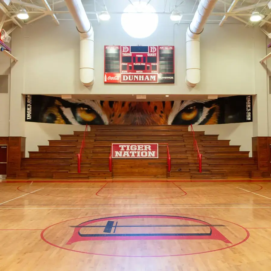 Interior photo of the Dunham Competition gym with a tiger eye banner in the background