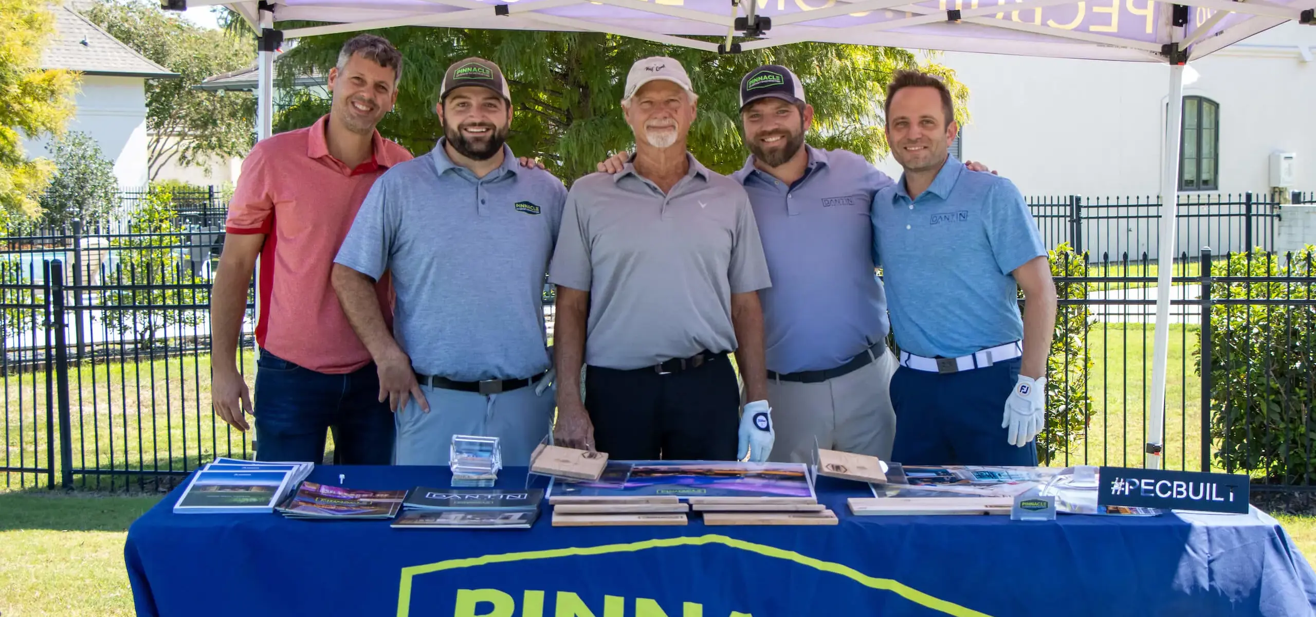 Corporate sponsors at a tent at Dunham golf event