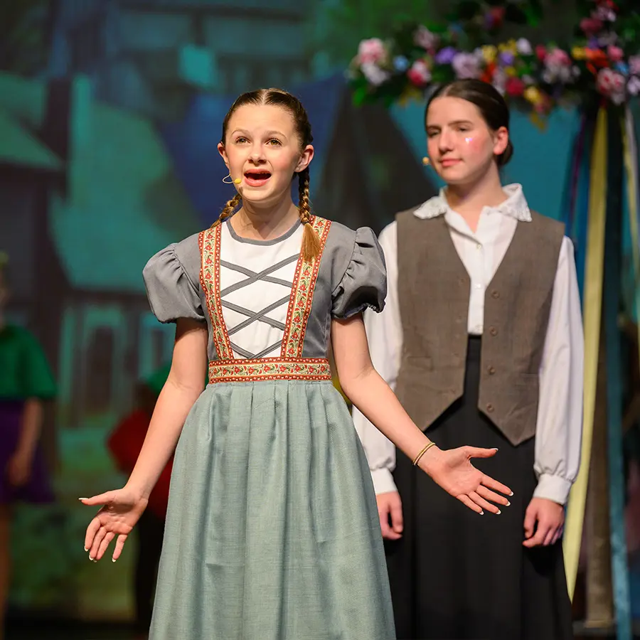 Two Dunham middle school performers singing in musical.