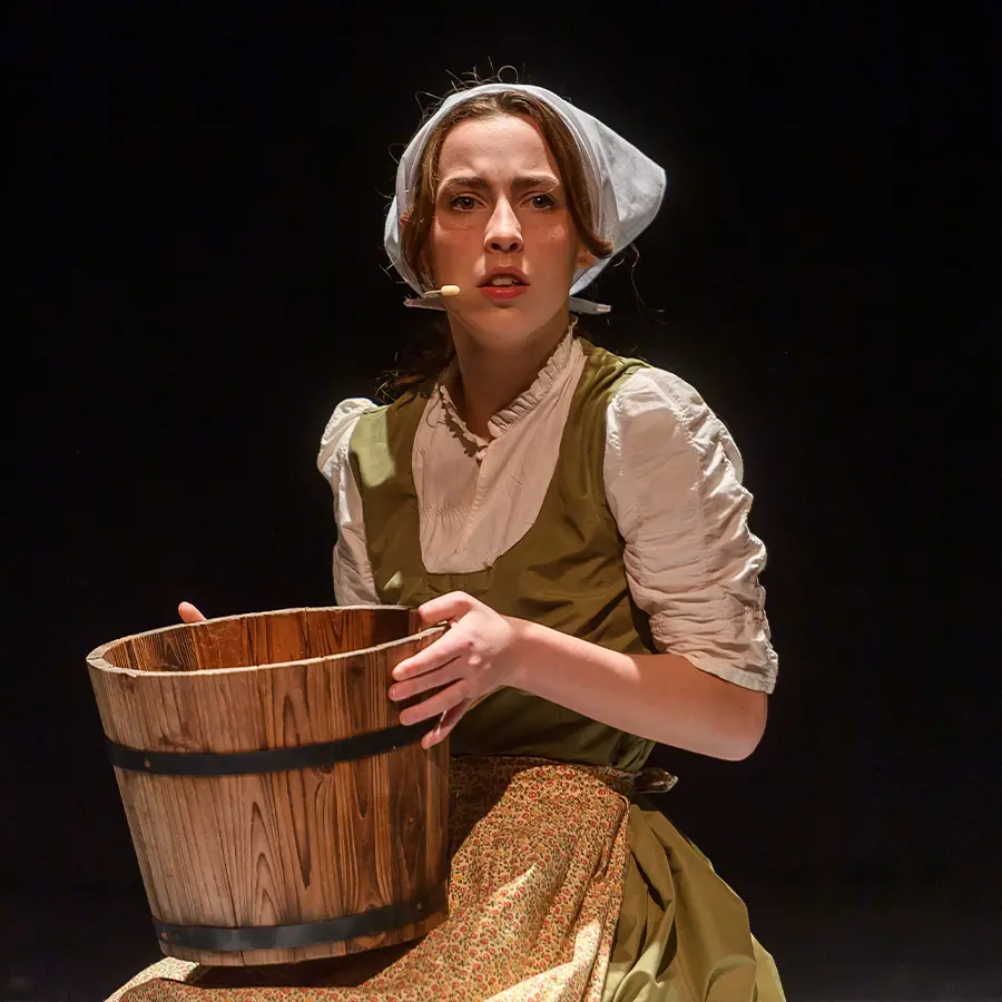 Dunham upper school actress performing in musical.