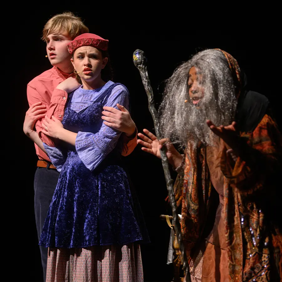 Three Dunham upper school performers singing in musical.