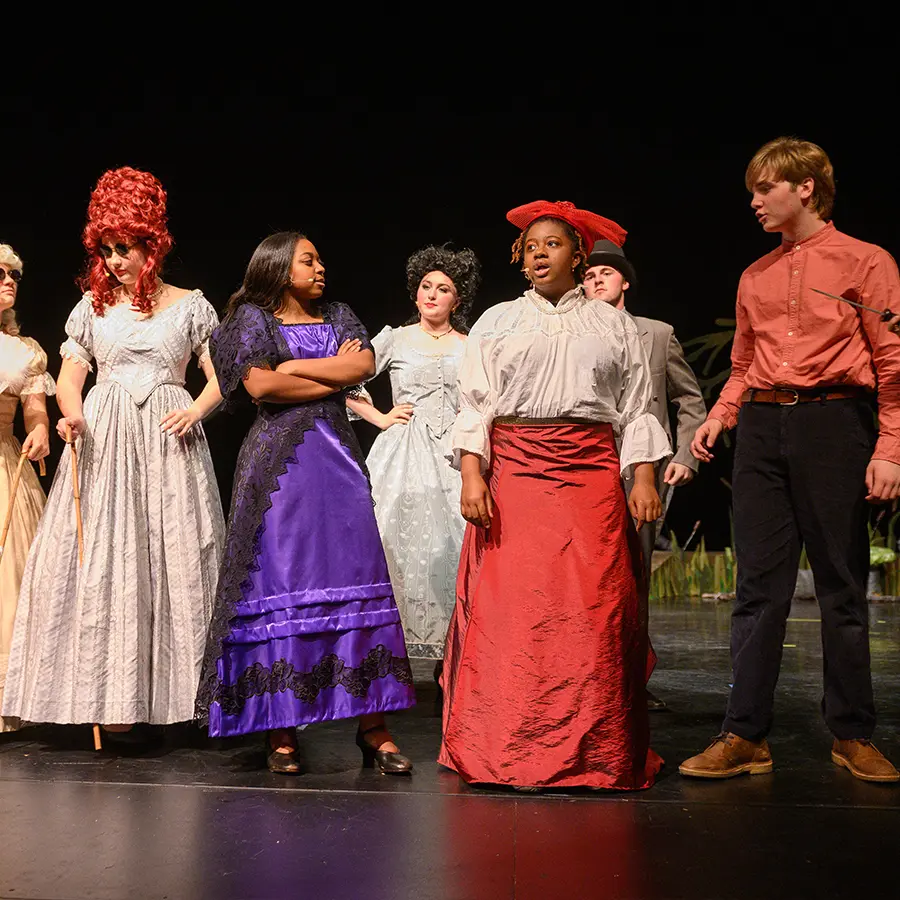 Dunham upper school ensemble singing in musical.