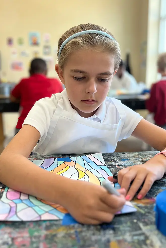 Dunham middle school girl working on painting in class.