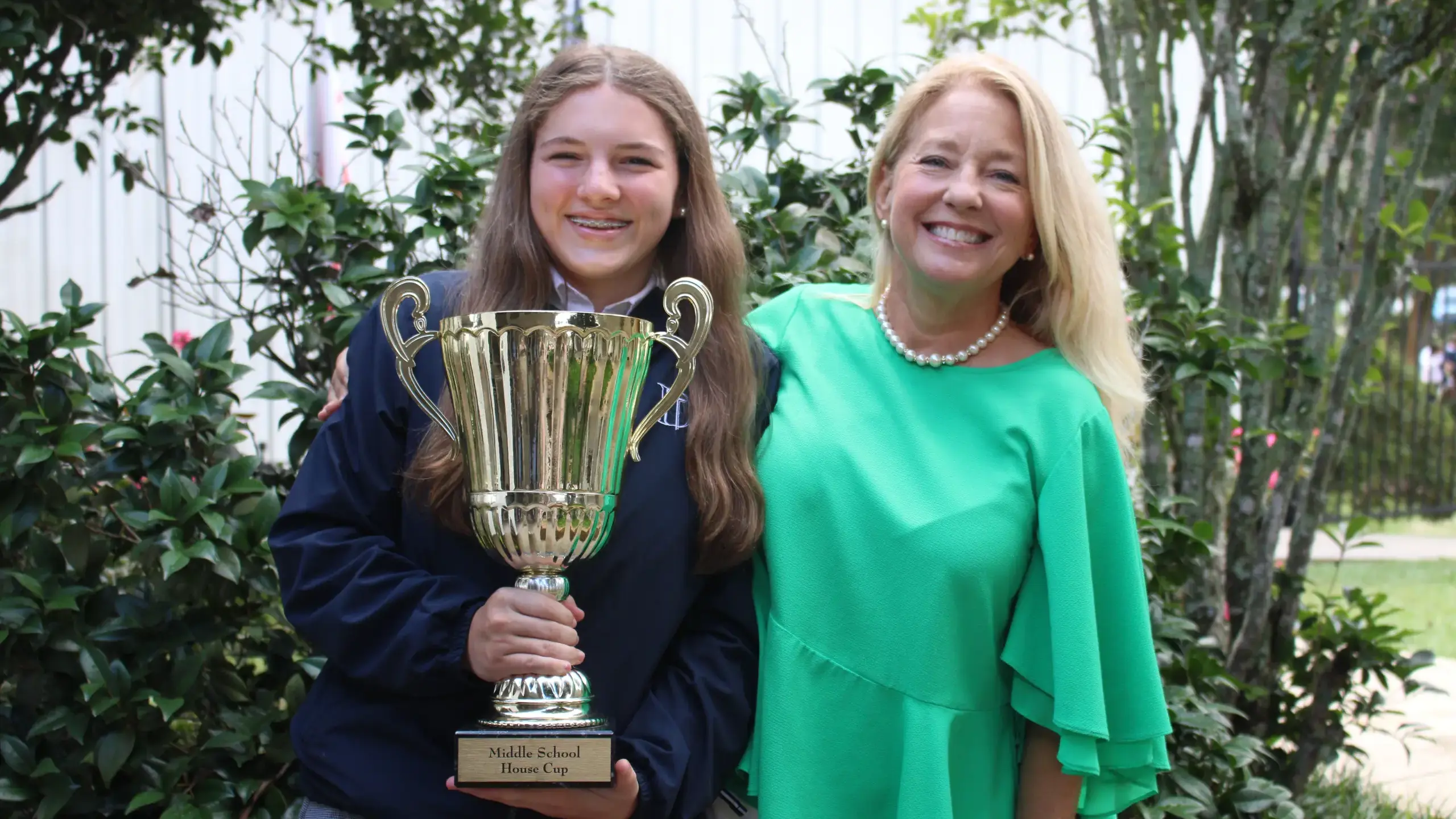 Dunham Middle School House Captain holding the House CupHero Banner 2