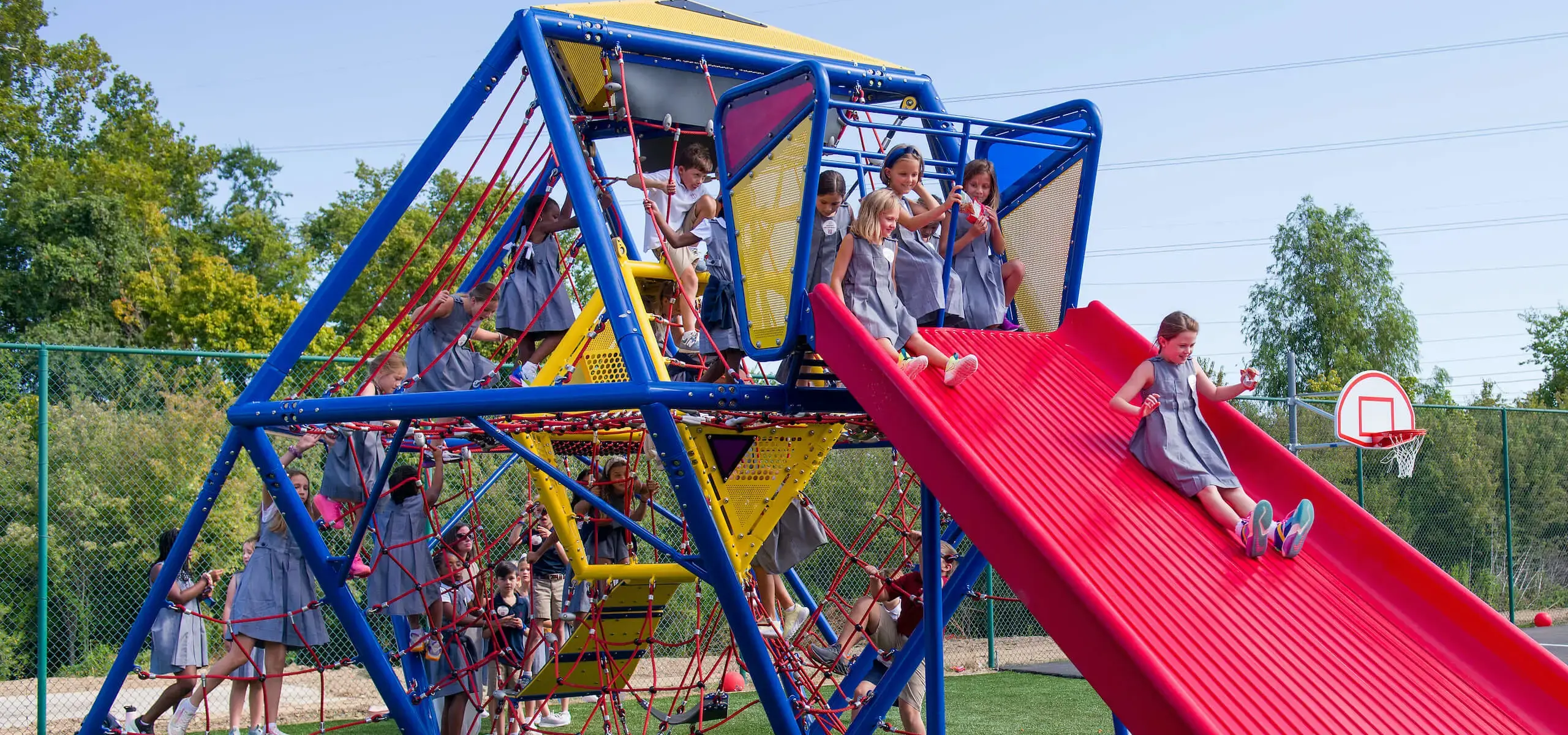 Dunham lower school students playing during recess on playground equipment.