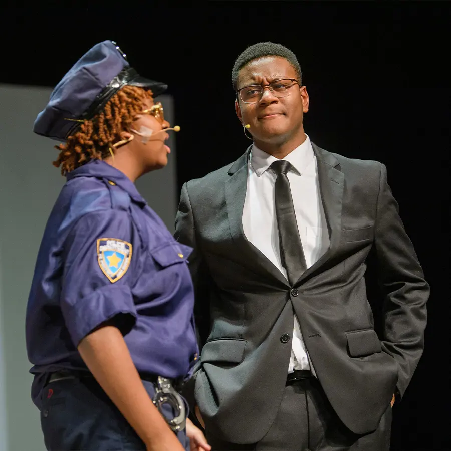 Two Dunham upper school performers acting in play.