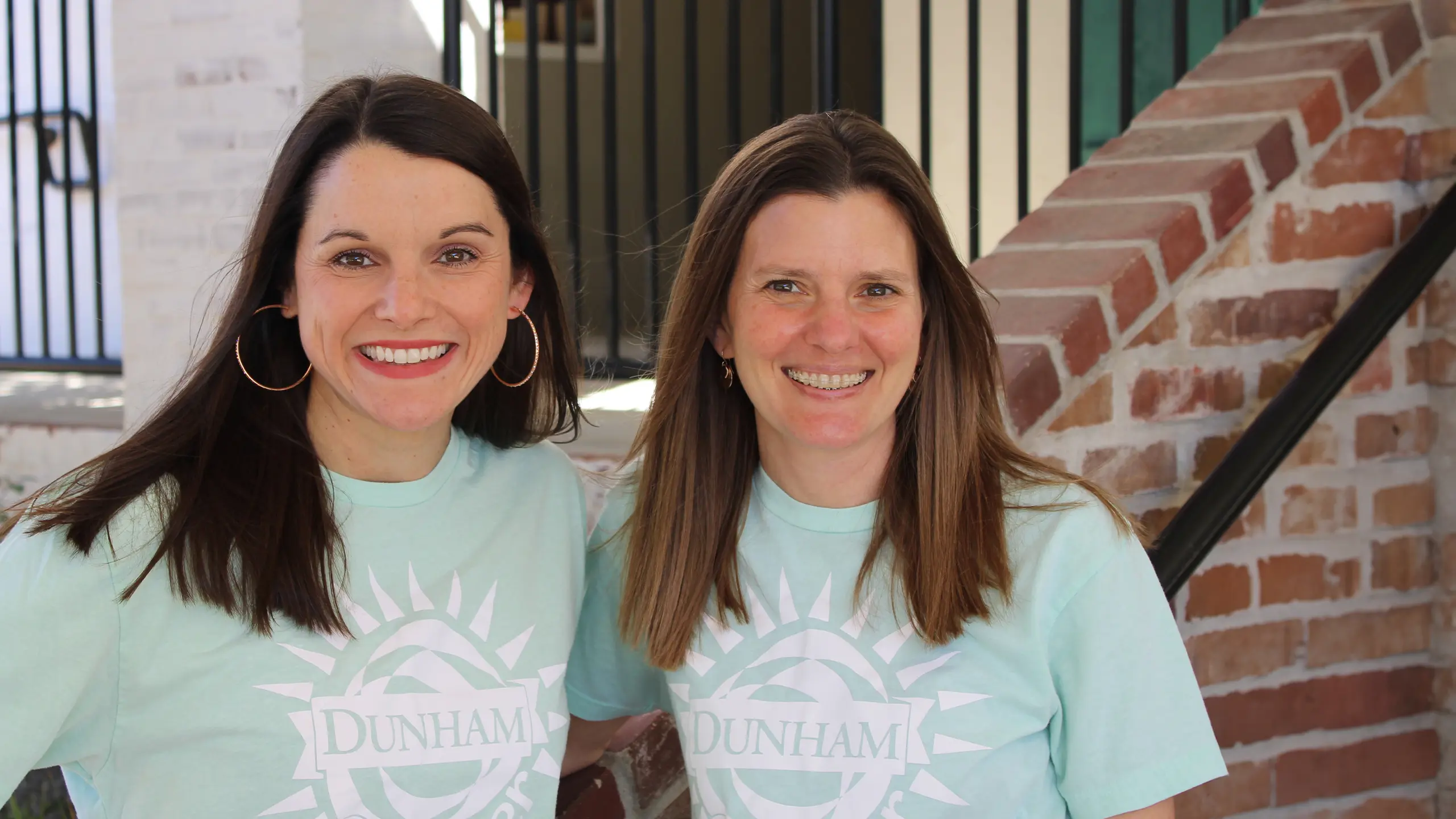 Two members of the Dunham Summer Camp staff smiling